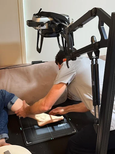A radiographer positioning a patient’s leg for a mobile X-ray at home