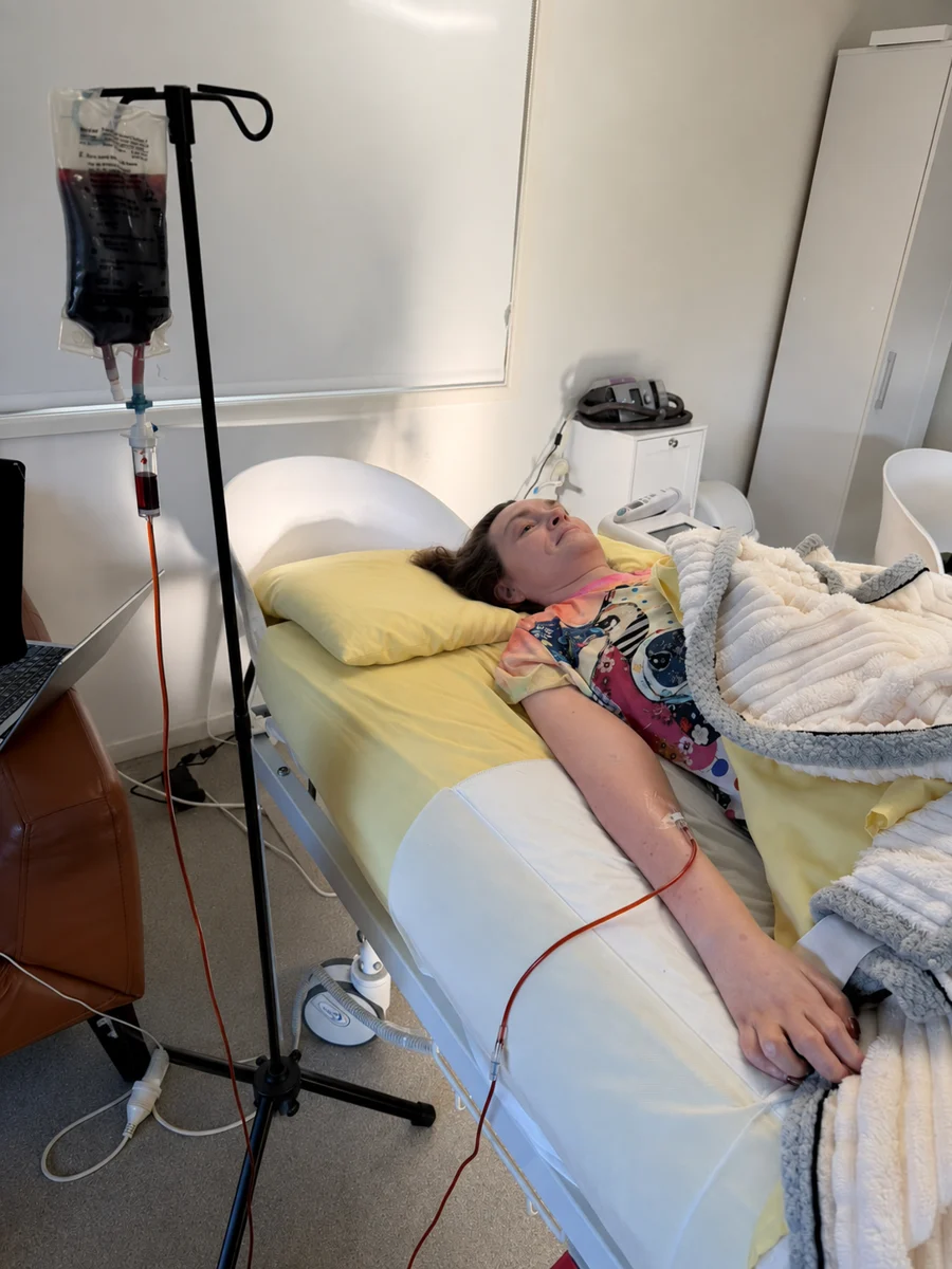 A person resting comfortably during an in-home IV infusion